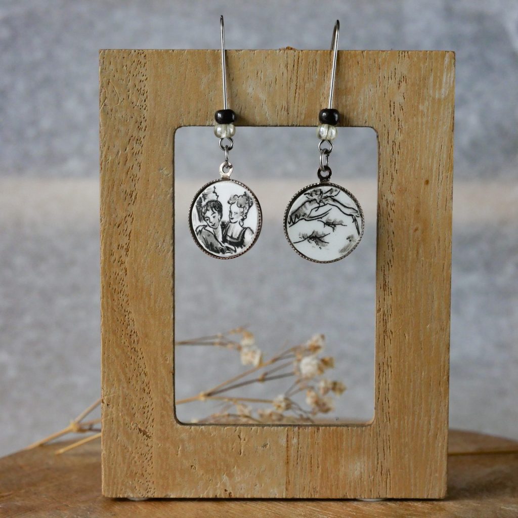 Boucle d'oreille pendante noire et blanche avec perles avec motif personnage 